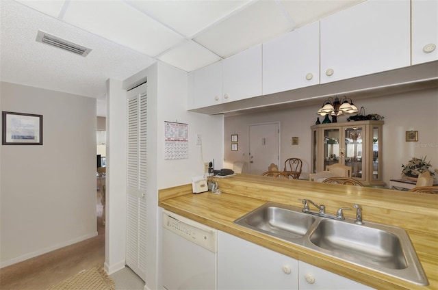 kitchen featuring white cabinetry, sink, and white dishwasher