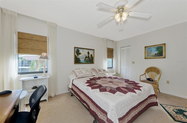 carpeted bedroom with a closet and ceiling fan