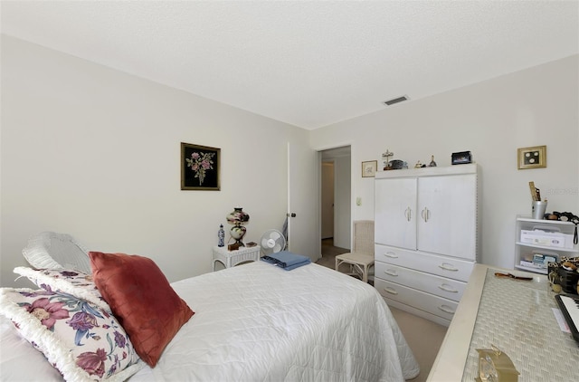 carpeted bedroom featuring a textured ceiling