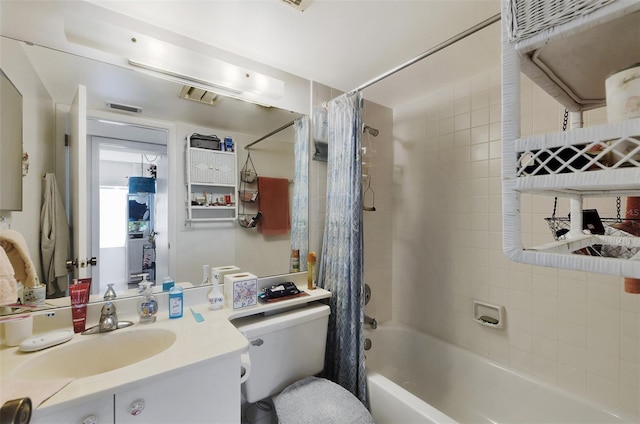 full bathroom with vanity, shower / tub combo with curtain, and toilet