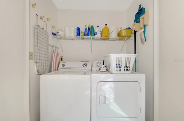 clothes washing area with separate washer and dryer