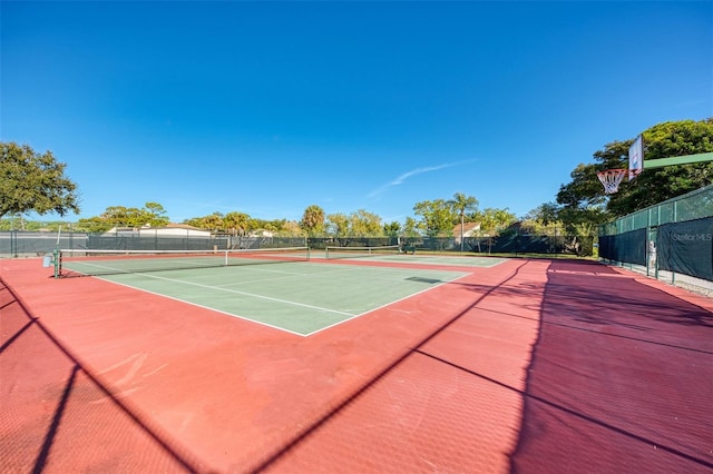 view of tennis court featuring basketball court