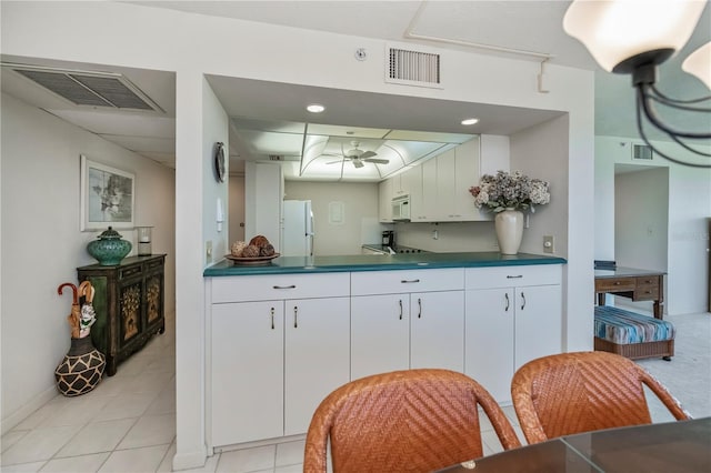 kitchen featuring ceiling fan, white appliances, white cabinets, and light tile patterned flooring