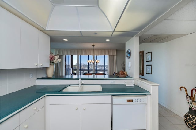 kitchen with sink, white cabinetry, decorative light fixtures, a chandelier, and white dishwasher