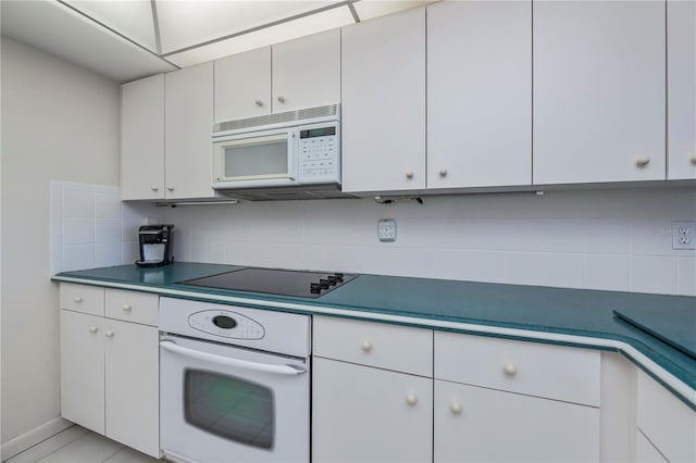 kitchen with white cabinetry, white appliances, and tasteful backsplash