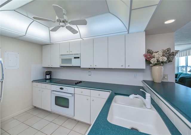 kitchen with white cabinetry, sink, light tile patterned floors, and white appliances