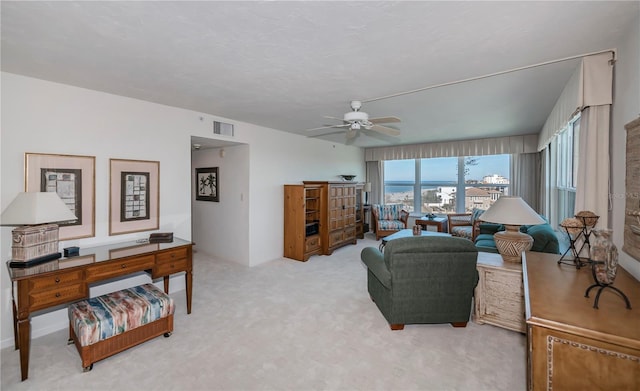 living room featuring carpet floors and ceiling fan