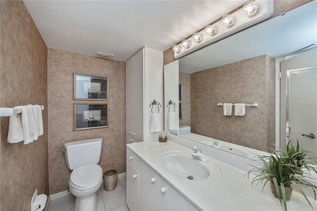 bathroom featuring tile patterned flooring, vanity, and toilet