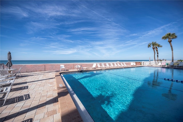 view of swimming pool featuring a water view