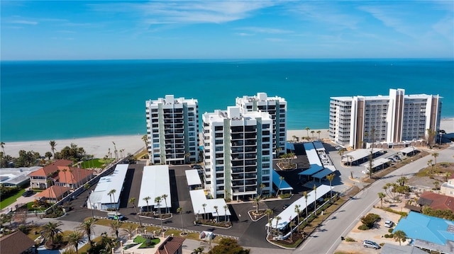 bird's eye view featuring a water view and a beach view