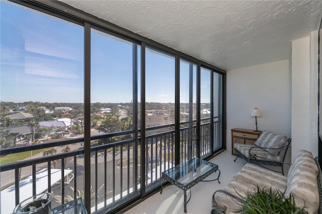 627 Alhambra Rd Unit 601, Venice, FL 34285 - sunroom with a textured ceiling, expansive windows, and concrete flooring