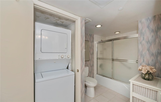 627 Alhambra Rd Unit 601, Venice, FL 34285 - bathroom featuring stacked washer / drying machine, toilet, shower / bath combination with glass door, tile patterned flooring, and recessed lighting