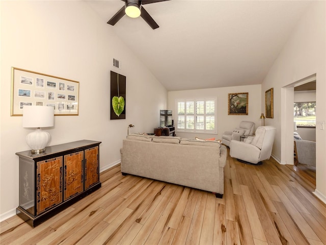 living room with ceiling fan, high vaulted ceiling, and light hardwood / wood-style floors