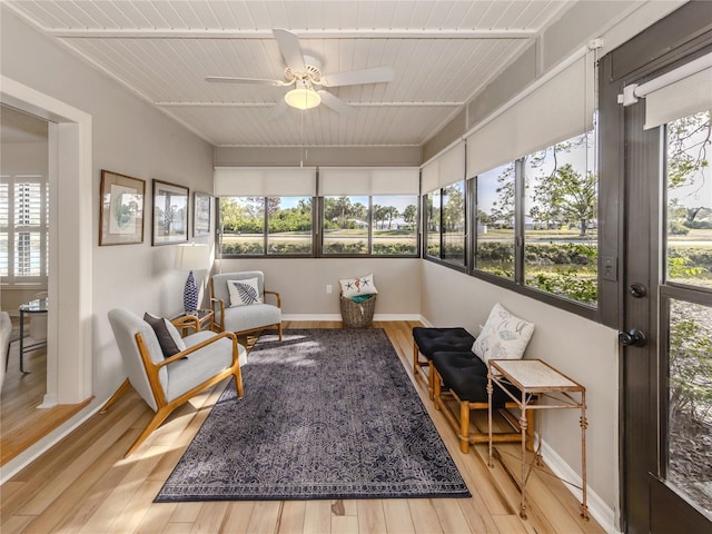 sunroom / solarium featuring wood ceiling and ceiling fan