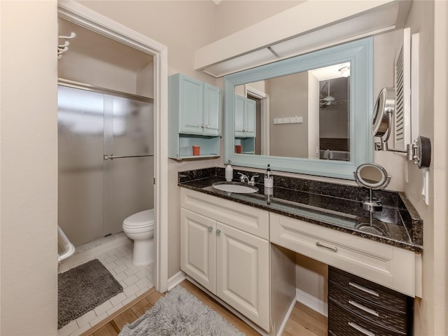 bathroom with vanity, wood-type flooring, and toilet