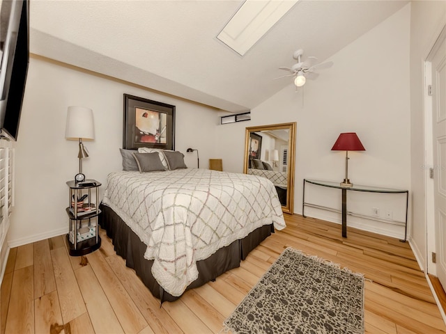 bedroom with hardwood / wood-style flooring, ceiling fan, and lofted ceiling