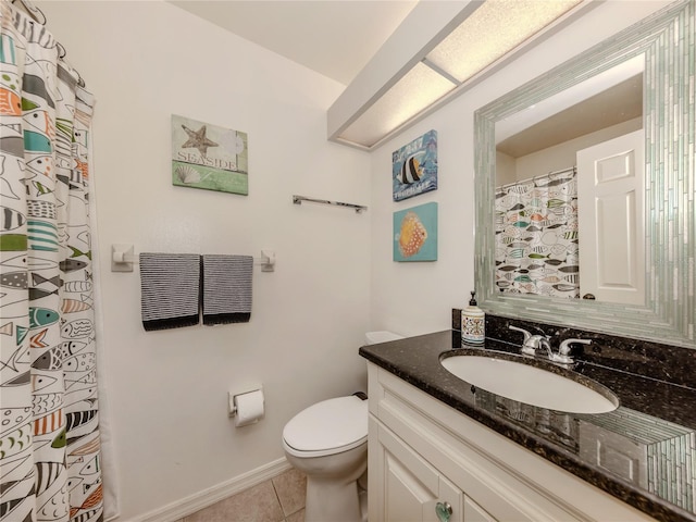 bathroom featuring vanity, tile patterned floors, and toilet