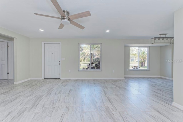 unfurnished living room with recessed lighting, baseboards, and ceiling fan