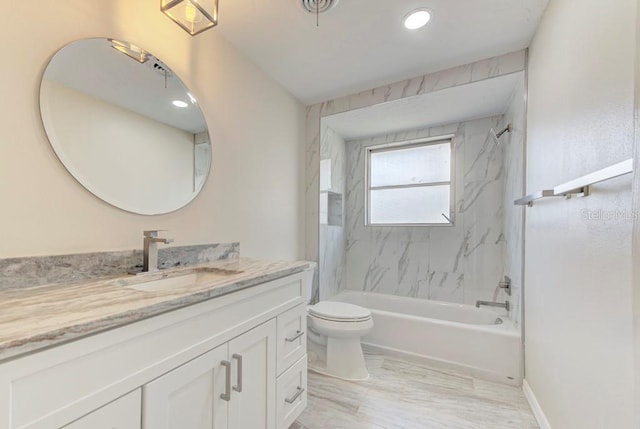 bathroom with baseboards, toilet, shower / washtub combination, and vanity