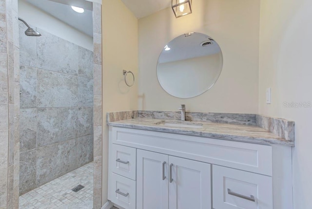 bathroom featuring walk in shower and vanity