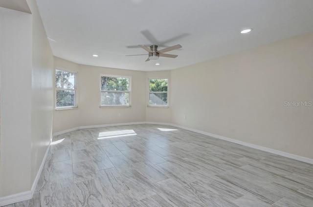 spare room with plenty of natural light and ceiling fan