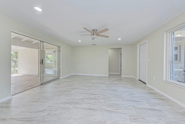 spare room featuring a ceiling fan, recessed lighting, and baseboards