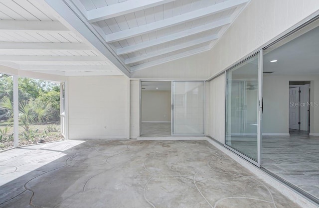 interior space featuring vaulted ceiling with beams