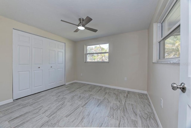 unfurnished bedroom with a closet, baseboards, and ceiling fan