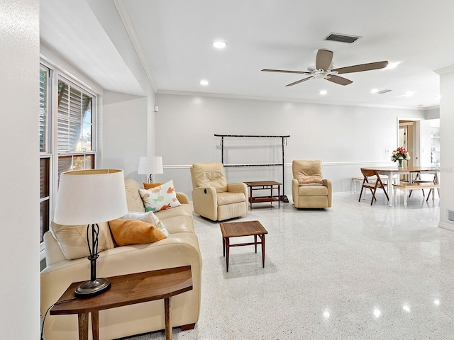 living room featuring ornamental molding and ceiling fan