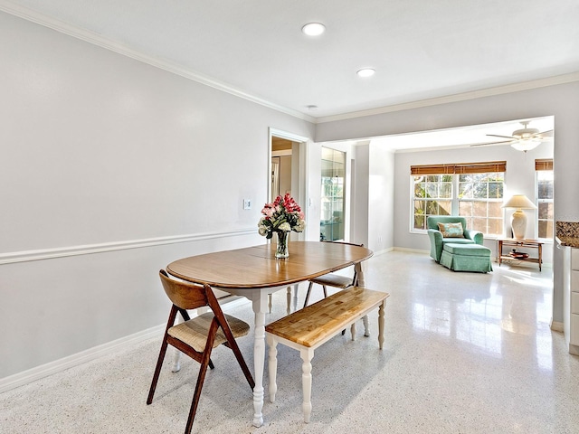 dining area with crown molding and ceiling fan