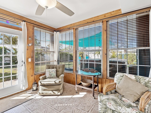 sunroom featuring ceiling fan and a healthy amount of sunlight