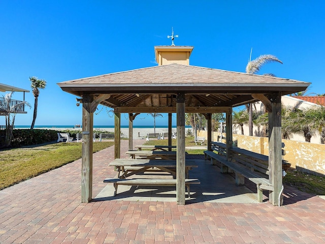 view of community featuring a water view, a yard, and a gazebo