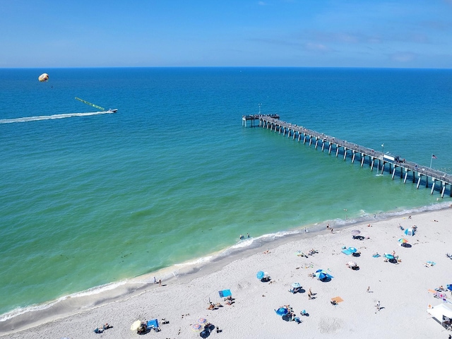 birds eye view of property featuring a water view and a beach view