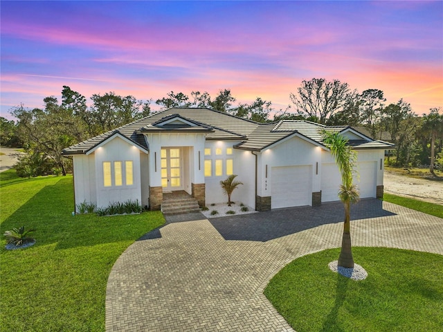 view of front facade with a garage and a yard