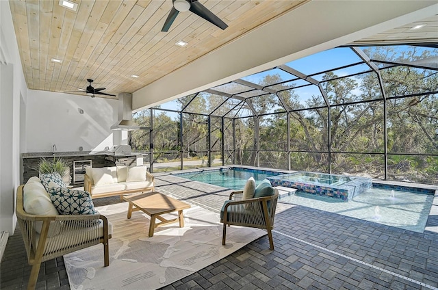 view of pool featuring outdoor lounge area, exterior kitchen, an in ground hot tub, a lanai, and a patio area