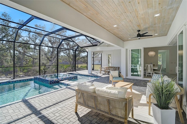 view of swimming pool featuring an in ground hot tub, ceiling fan, a patio area, and glass enclosure