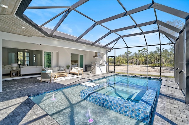 view of swimming pool featuring area for grilling, glass enclosure, an in ground hot tub, an outdoor hangout area, and a patio