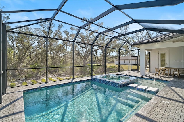 view of swimming pool featuring an in ground hot tub, glass enclosure, and a patio