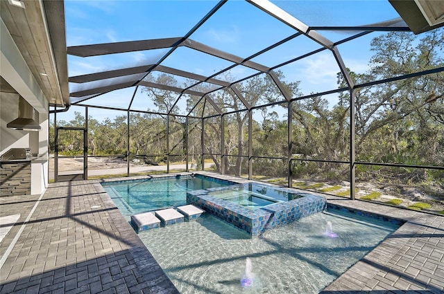 view of swimming pool featuring an in ground hot tub, a lanai, and a patio area