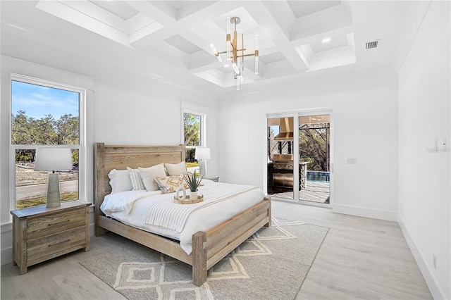 bedroom with coffered ceiling, access to exterior, light hardwood / wood-style flooring, and a notable chandelier