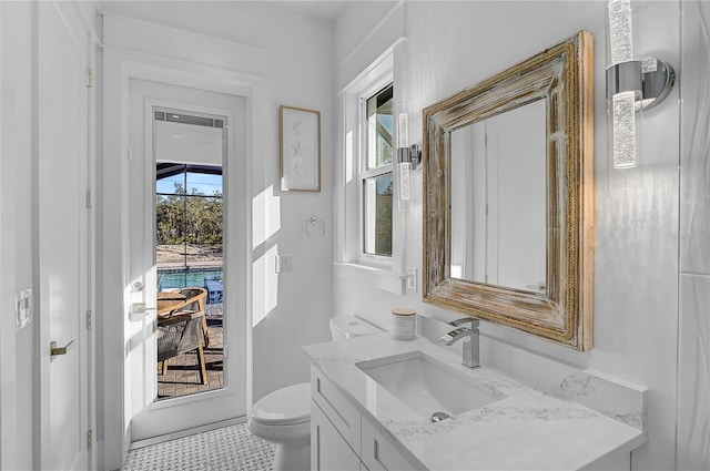 bathroom featuring vanity and toilet