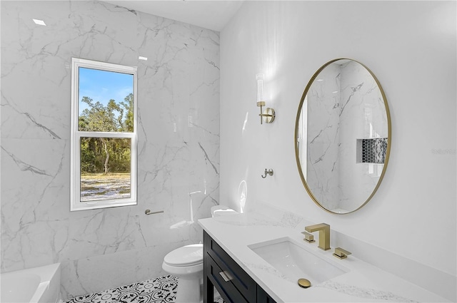 bathroom featuring vanity, a bath, and toilet