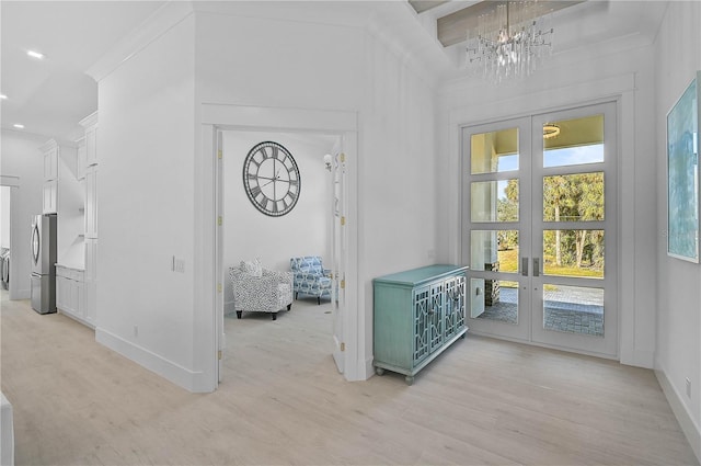 interior space with crown molding, light hardwood / wood-style flooring, and french doors