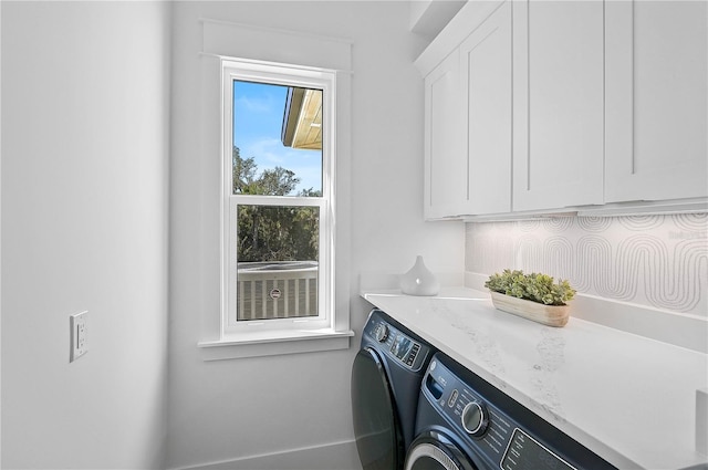 laundry room featuring cabinets and washing machine and clothes dryer