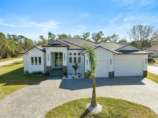 ranch-style home with a garage and a front lawn