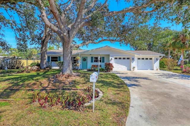 ranch-style house featuring a garage and a front yard