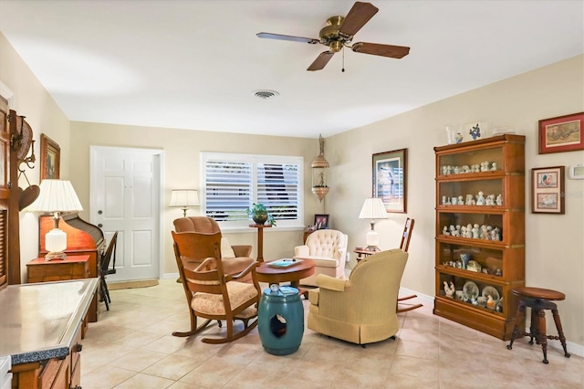 living area with light tile patterned flooring and ceiling fan