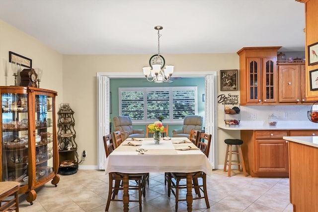 tiled dining area with a chandelier