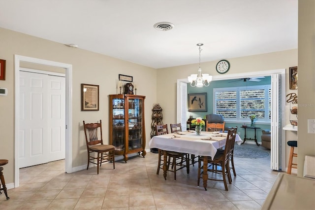 dining room with ceiling fan with notable chandelier and light tile patterned floors