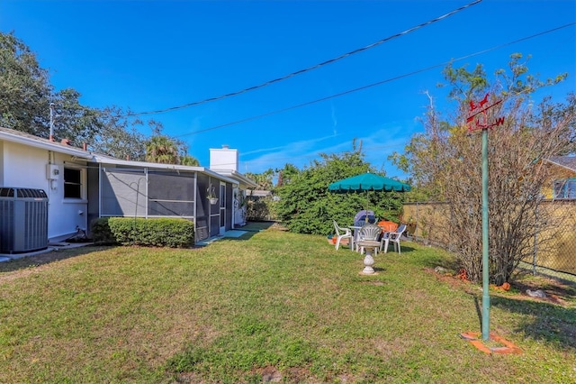 view of yard with central AC and a sunroom